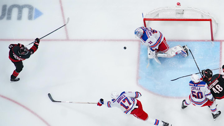 Apr 12, 2025; Raleigh, North Carolina, USA;  New York Rangers goaltender Igor Shesterkin (31) stops the shot by Carolina Hurricanes center Logan Stankoven (22) during the second period at Lenovo Center. Mandatory Credit: James Guillory-Imagn Images