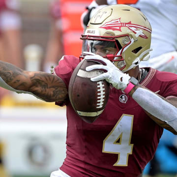 Oct 14, 2023; Tallahassee, Florida, USA; Florida State Seminoles wide receiver Keon Coleman (4) celebrates after catching a pass over Syracuse Orange defensive back Jason Simmons Jr. (6) (not pictured) during the first quarter at Doak S. Campbell Stadium. Mandatory Credit: Melina Myers-USA TODAY Sports