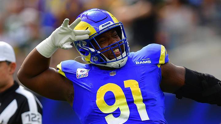 Oct 6, 2024; Inglewood, California, USA; Los Angeles Rams defensive tackle Kobie Turner (91) reacts after sacking Green Bay Packers quarterback Jordan Love (10) during the first half at SoFi Stadium. Mandatory Credit: Gary A. Vasquez-Imagn Images