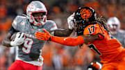 UNLV Rebels running back Jai'Den Thomas (9) stiff arms Oregon State Beavers defensive back Skyler Thomas (17) during an NCAA football game against UNLV at Reser Stadium