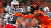 UNLV Rebels running back Jai'Den Thomas (9) stiff arms Oregon State Beavers defensive back Skyler Thomas (17) during an NCAA football game against UNLV at Reser Stadium