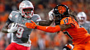UNLV Rebels running back Jai'Den Thomas (9) stiff arms Oregon State Beavers defensive back Skyler Thomas (17) during an NCAA football game against UNLV at Reser Stadium