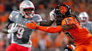 UNLV Rebels running back Jai'Den Thomas (9) stiff arms Oregon State Beavers defensive back Skyler Thomas (17) during an NCAA football game against UNLV at Reser Stadium