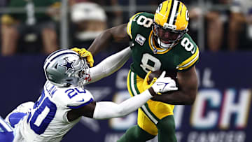 Green Bay Packers running back Josh Jacobs (8) runs against Dallas Cowboys cornerback Kaiir Elam (20) in the first quarter at AT&T Stadium.