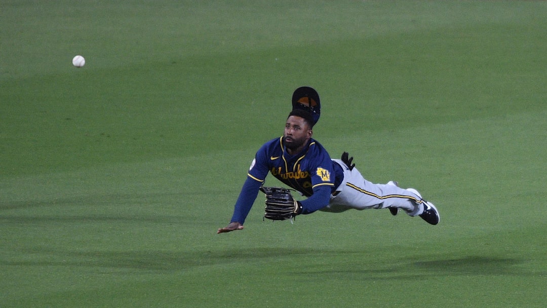 Apr 20, 2021; San Diego, California, USA; Milwaukee Brewers center fielder Jackie Bradley Jr. (41) dives but cannot make the catch on a single by San Diego Padres center fielder Jorge Mateo (not pictured) during the fifth inning at Petco Park. Mandatory Credit: Orlando Ramirez-Imagn Images