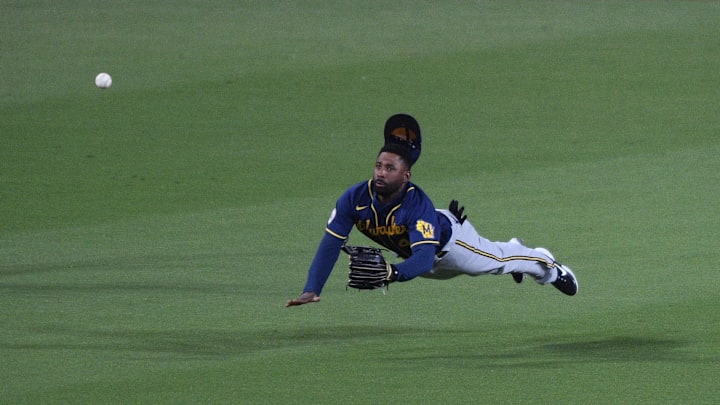Apr 20, 2021; San Diego, California, USA; Milwaukee Brewers center fielder Jackie Bradley Jr. (41) dives but cannot make the catch on a single by San Diego Padres center fielder Jorge Mateo (not pictured) during the fifth inning at Petco Park. Mandatory Credit: Orlando Ramirez-Imagn Images