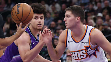 Oct 27, 2025; Salt Lake City, Utah, USA; Utah Jazz guard Walter Clayton Jr. (left) and Phoenix Suns guard Collin Gillespie (12) prepare for a jump ball during the second half at Delta Center. Mandatory Credit: Rob Gray-Imagn Images