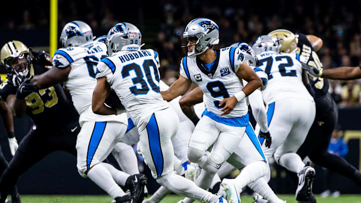 Carolina Panthers quarterback Bryce Young (9) hands off to running back Chuba Hubbard (30)