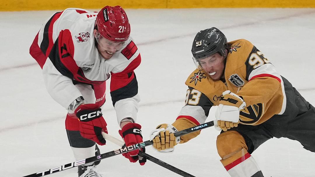 Jun 14, 2026; Las Vegas, Nevada, USA; Vegas Golden Knights right wing Mitch Marner (93) reaches for the puck against Carolina Hurricanes defenseman Alexander Nikishin (21) during the first period in game six of the 2026 Stanley Cup Final at T-Mobile Arena. Mandatory Credit: Lucas Peltier-Imagn Images