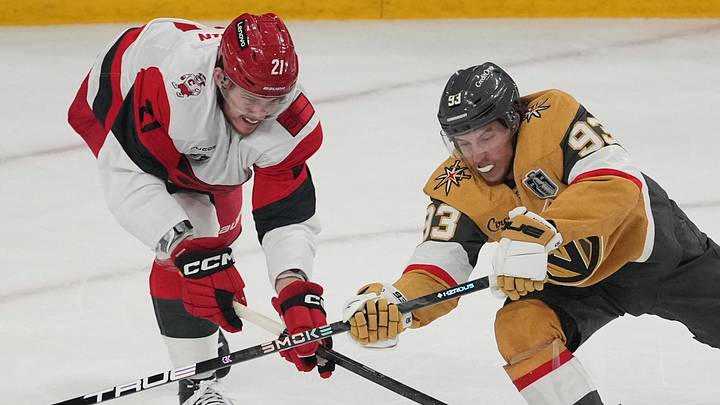 Jun 14, 2026; Las Vegas, Nevada, USA; Vegas Golden Knights right wing Mitch Marner (93) reaches for the puck against Carolina Hurricanes defenseman Alexander Nikishin (21) during the first period in game six of the 2026 Stanley Cup Final at T-Mobile Arena. Mandatory Credit: Lucas Peltier-Imagn Images