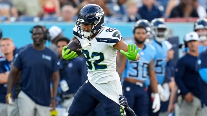 Seattle Seahawks wide receiver Cody White (82) is pulled down by Tennessee Titans safety Mike Brown (44) during the second quarter at Nissan Stadium in Nashville, Tenn., Saturday, Aug. 17, 2024.