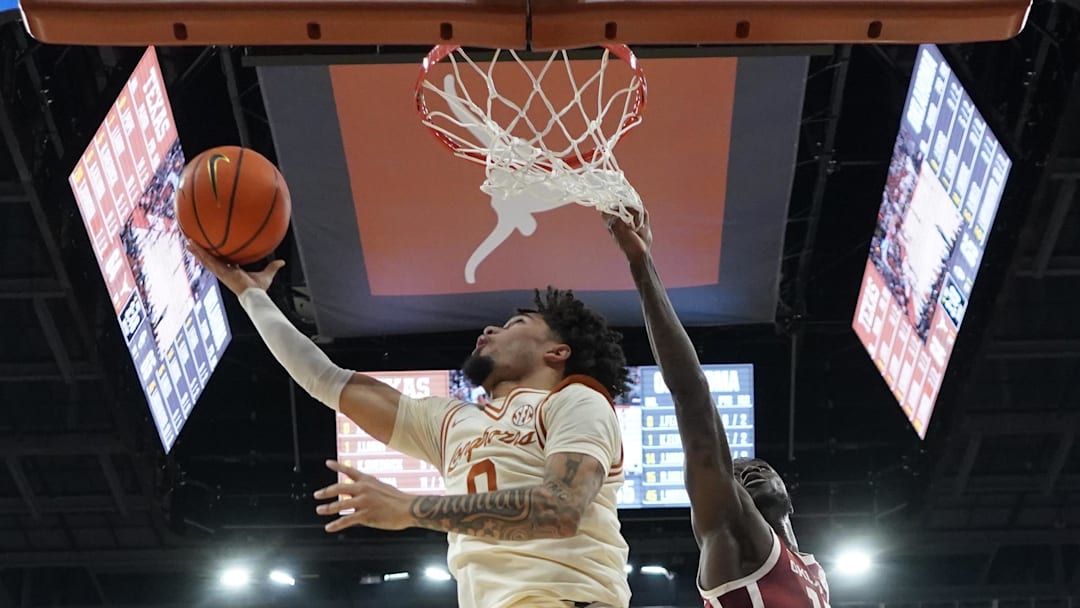 Mar 8, 2025; Austin, Texas, USA; Texas Longhorns guard Jordan Pope (0) drives to the basket against Oklahoma Sooners guard Duke Miles (15) during the second half at Moody Center. Mandatory Credit: Scott Wachter-Imagn Images