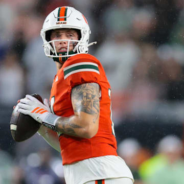 Sep 20, 2025; Miami Gardens, Florida, USA; Miami Hurricanes quarterback Carson Beck (11) looks for passing option against the Florida Gators during the first quarter at Hard Rock Stadium. Mandatory Credit: Sam Navarro-Imagn Images