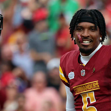 Sep 8, 2024; Tampa, Florida, USA;  Washington Commanders quarterback Jayden Daniels (5) looks on after he lost his helmet against the Tampa Bay Buccaneers during the first half at Raymond James Stadium. Mandatory Credit: Kim Klement Neitzel-Imagn Images