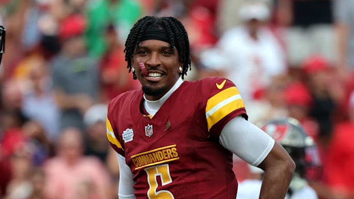 Sep 8, 2024; Tampa, Florida, USA;  Washington Commanders quarterback Jayden Daniels (5) looks on after he lost his helmet against the Tampa Bay Buccaneers during the first half at Raymond James Stadium. Mandatory Credit: Kim Klement Neitzel-Imagn Images