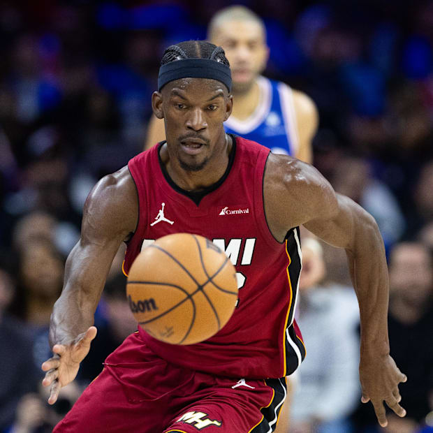 Miami Heat forward Jimmy Butler picks up a loose ball against the Philadelphia 76ers during a play-in game in 2023-24.