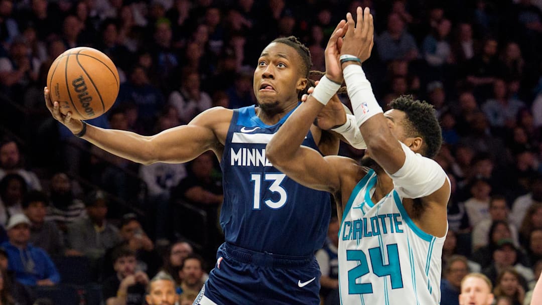 Apr 5, 2026; Minneapolis, Minnesota, USA; Minnesota Timberwolves guard Ayo Dosunmu (13) shoots as Charlotte Hornets forward Brandon Miller (24) defends in the second quarter at Target Center. Mandatory Credit: Matt Blewett-Imagn Images