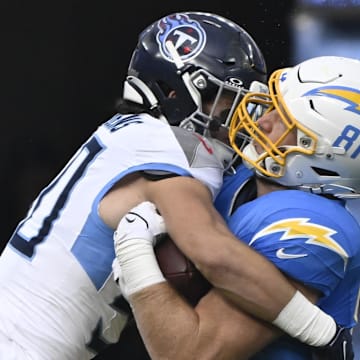 Nov 10, 2024; Inglewood, California, USA; Tennessee Titans linebacker Jack Gibbens (50) tackles Los Angeles Chargers tight end Will Dissly (81) after a short pass during the first quarter at SoFi Stadium. Mandatory Credit: Robert Hanashiro-Imagn Images