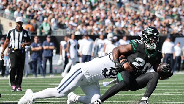 New York Jets running back Breece Hall is tackled by Dallas Cowboys defensive tackle Solomon Thomas.