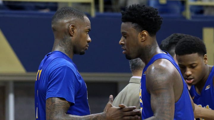 Feb 25, 2017; Pittsburgh, PA, USA;  Pittsburgh Panthers forward Michael Young (L) and forward Jamel Artis (R) shake hands after exiting the game against the North Carolina Tar Heels during the second half at the Petersen Events Center. The Tar Heels won 85-67. Mandatory Credit: Charles LeClaire-USA TODAY Sports