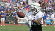 Bills wide receiver Keon Coleman pulls in a pass close to the sideline during route drills.