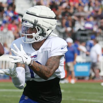 Bills wide receiver Keon Coleman pulls in a pass close to the sideline during route drills.