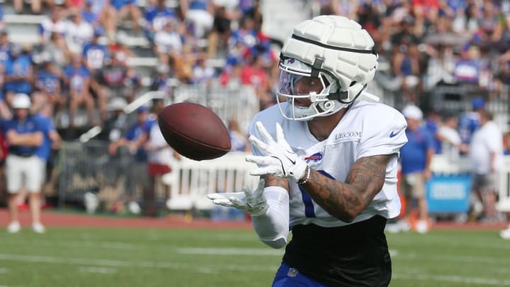 Bills wide receiver Keon Coleman pulls in a pass close to the sideline during route drills.