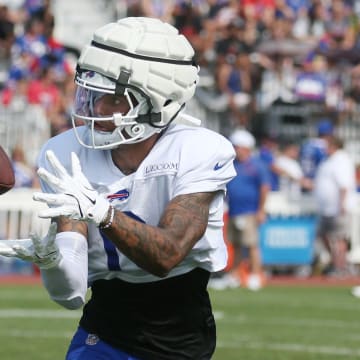 Bills wide receiver Keon Coleman pulls in a pass close to the sideline during route drills.