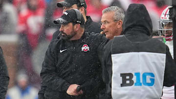 Ohio State Buckeyes head coach Ryan Day gets a hand shake from former head coach Urban Meyer during the NCAA football game against the Michigan Wolverines at Michigan Stadium in Ann Arbor, Mich. on Nov. 29, 2025. Ohio State won 27-9.