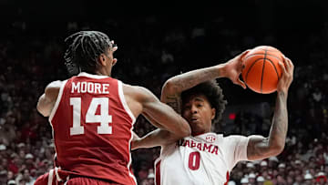 Jan 4, 2025; Tuscaloosa, AL, USA; Alabama guard Labaron Philon (0) takes an elbow from Oklahoma forward Jalon Moore (14) as he drives into the lane at Coleman Coliseum. Alabama defeated Oklahoma 107-79. Mandatory Credit: Gary Cosby Jr.-Tuscaloosa News