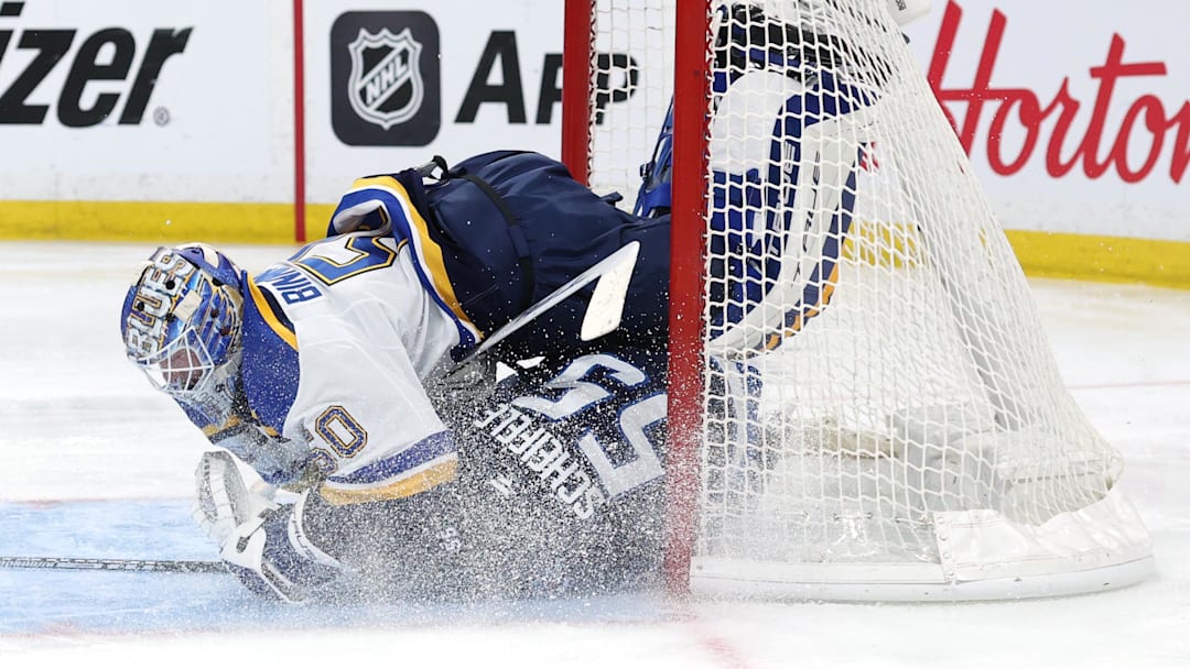 Apr 21, 2025; Winnipeg, Manitoba, CAN;Winnipeg Jets center Mark Scheifele (55) slides into St. Louis Blues goaltender Jordan Binnington (50) in the second period in game two of the first round of the 2025 Stanley Cup Playoffs at Canada Life Centre. Mandatory Credit: James Carey Lauder-Imagn Images