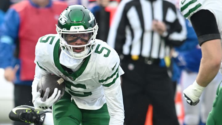 Dec 29, 2024; Orchard Park, New York, USA; New York Jets wide receiver Garrett Wilson (5) breaks a tackle by Buffalo Bills cornerback Rasul Douglas (31) in the third quarter at Highmark Stadium. Mandatory Credit: Mark Konezny-Imagn Images