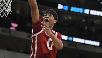 Mar 21, 2025; Raleigh, NC, USA;  Oklahoma Sooners guard Jeremiah Fears (0) puts up shot against Connecticut Huskies forward Liam McNeeley (30) during the second half at Lenovo Center. Mandatory Credit: Zachary Taft-Imagn Images