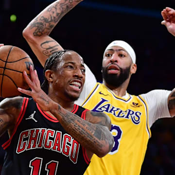 Jan 25, 2024; Los Angeles, California, USA; Chicago Bulls forward DeMar DeRozan (11) moves the ball against Los Angeles Lakers forward Anthony Davis (3) and guard D'Angelo Russell (1) during the second half at Crypto.com Arena. 