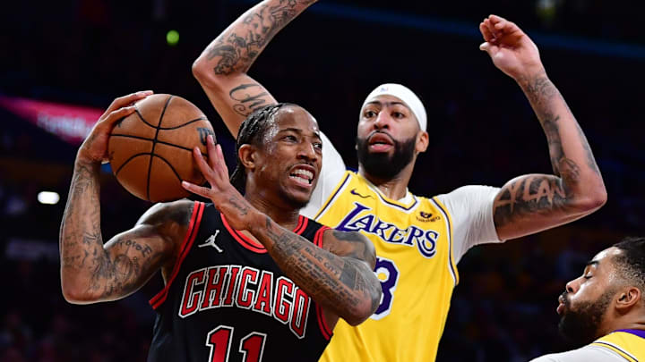 Jan 25, 2024; Los Angeles, California, USA; Chicago Bulls forward DeMar DeRozan (11) moves the ball against Los Angeles Lakers forward Anthony Davis (3) and guard D'Angelo Russell (1) during the second half at Crypto.com Arena. 