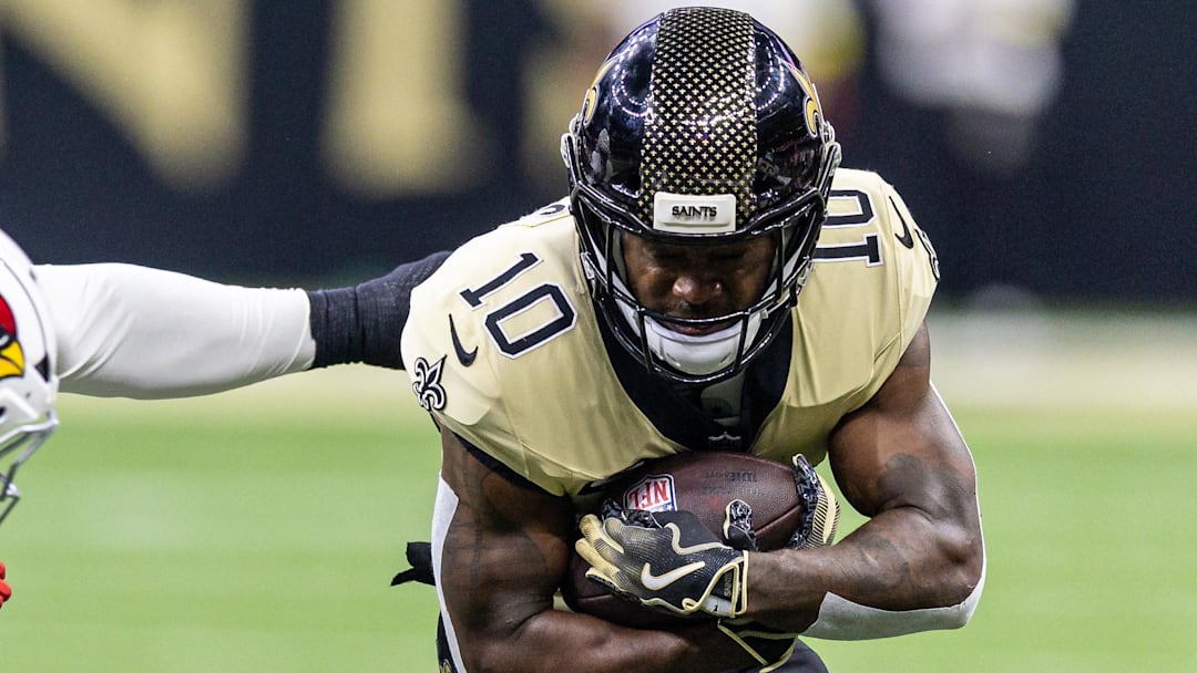 New Orleans Saints wide receiver Brandin Cooks is tackled by Arizona Cardinals defenders.