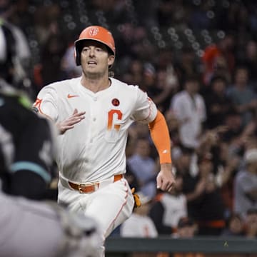 Sep 3, 2024; San Francisco, California, USA;  Arizona Diamondbacks catcher Jose Herrera (11) watches as San Francisco Giants right fielder Mike Yastrzemski (5) runs home to score during the ninth inning at Oracle Park. 