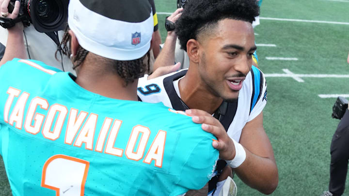 Oct 5, 2025; Charlotte, North Carolina, USA; Carolina Panthers quarterback Bryce Young (9) with Miami Dolphins quarterback Tua Tagovailoa (1) after the game at Bank of America Stadium.