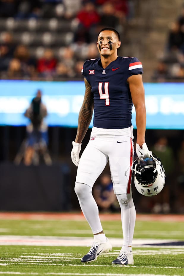 Arizona Wildcats wide receiver Tetairoa McMillan smiles at the scoreboard during the first quarter.