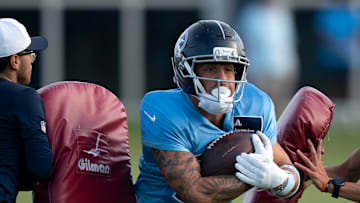 Tennessee Titans wide receiver Xavier Restrepo (87) punches through the pads during training camp at Ascension Saint Thomas Sports Park in Nashville, Tenn., Wednesday, July 30, 2025.