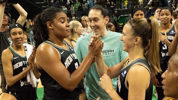 New York Liberty’s Nyara Sabally and Sabrina Ionescu celebrate with teammates.