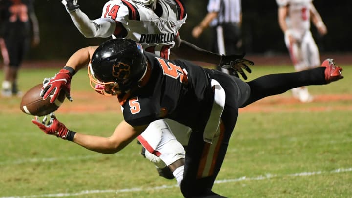 Jayvan Boggs of Cocoa makes an incredible catch despite the defense of Dunnellon's Damien Hemmings in the FHSAA football playoffs on Friday, November 17, 2023.