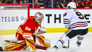 Nov 7, 2025; Calgary, Alberta, CAN; Chicago Blackhawks center Connor Bedard (98) scores a goal against Calgary Flames goaltender Dustin Wolf (32) during the third period at Scotiabank Saddledome. Mandatory Credit: Sergei Belski-Imagn Images