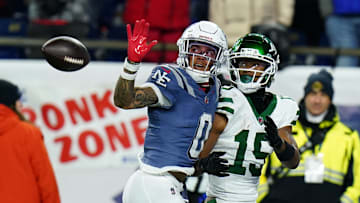 Nov 13, 2025; Foxborough, Massachusetts, USA; New England Patriots Christian Gonzalez cornerback (0) defends against New York Jets wide receiver Adonai Mitchell (15) in the fourth quarter at Gillette Stadium. Mandatory Credit: David Butler II-Imagn Images