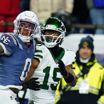Nov 13, 2025; Foxborough, Massachusetts, USA; New England Patriots Christian Gonzalez cornerback (0) defends against New York Jets wide receiver Adonai Mitchell (15) in the fourth quarter at Gillette Stadium. Mandatory Credit: David Butler II-Imagn Images