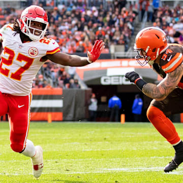 Nov 4, 2018; Cleveland, OH, USA; Kansas City Chiefs running back Kareem Hunt (27) pushes Cleveland Browns linebacker Tanner Vallejo (54) away as he runs the ball for a touchdown during the third quarter at FirstEnergy Stadium. Mandatory Credit: Scott R. Galvin-Imagn Images