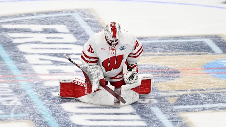Wisconsin Badgers goaltender Ava McNaughton stretches at center ice before playing against the Minnesota Gophers in an NCAA women's hockey Frozen Four semifinal Friday, March 21, 2025, at Ridder Arena in Minneapolis, Minnesota.
