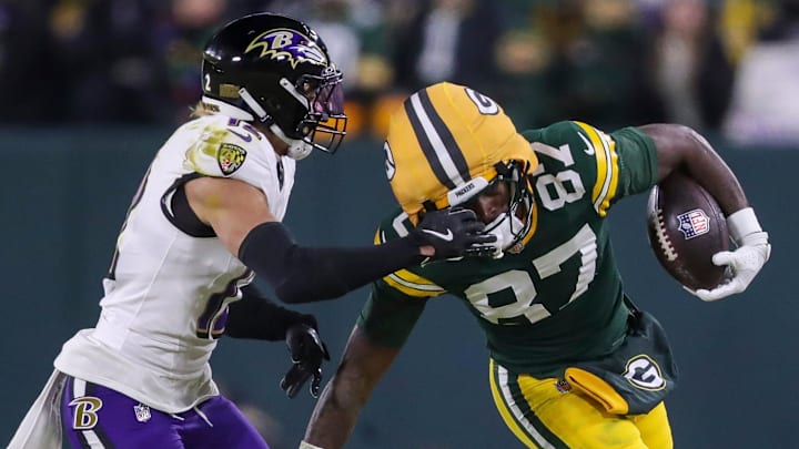 Green Bay Packers wide receiver Romeo Doubs (87) runs the ball as Baltimore Ravens safety Alohi Gilman (12) grabs his facemask on Saturday, December 27, 2025, at Lambeau Field in Green Bay, Wis. 
Tork Mason/USA TODAY NETWORK-Wisconsin