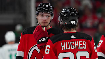 Feb 10, 2024; Raleigh, North Carolina, USA; New Jersey Devils center Jack Hughes (86) and defenseman Luke Hughes (43) talk against the Carolina Hurricanes during the first period at PNC Arena. Mandatory Credit: James Guillory-Imagn Images