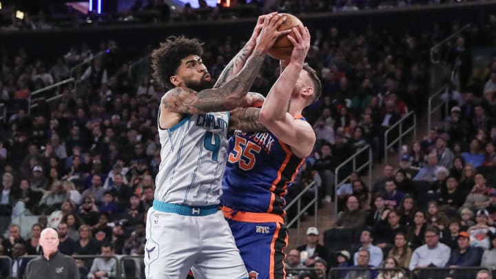Nov 12, 2023; New York, New York, USA;  Charlotte Hornets center Nick Richards (4) and New York Knicks center Isaiah Hartenstein (55) fight for a rebound in the third quarter at Madison Square Garden. Mandatory Credit: Wendell Cruz-USA TODAY Sports